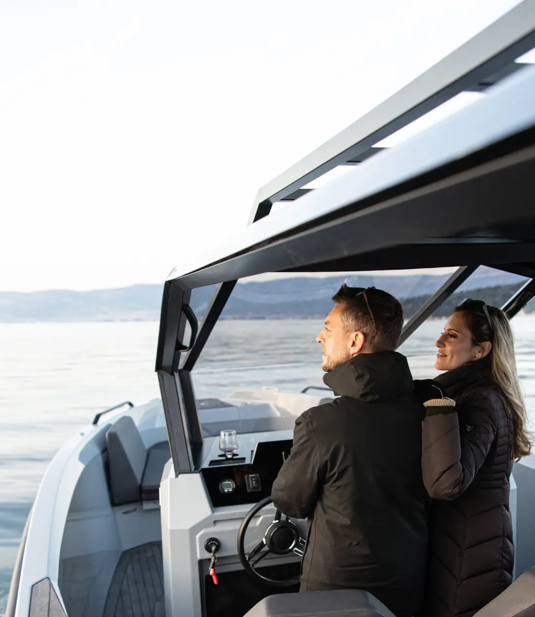 Couple at the helm at dusk