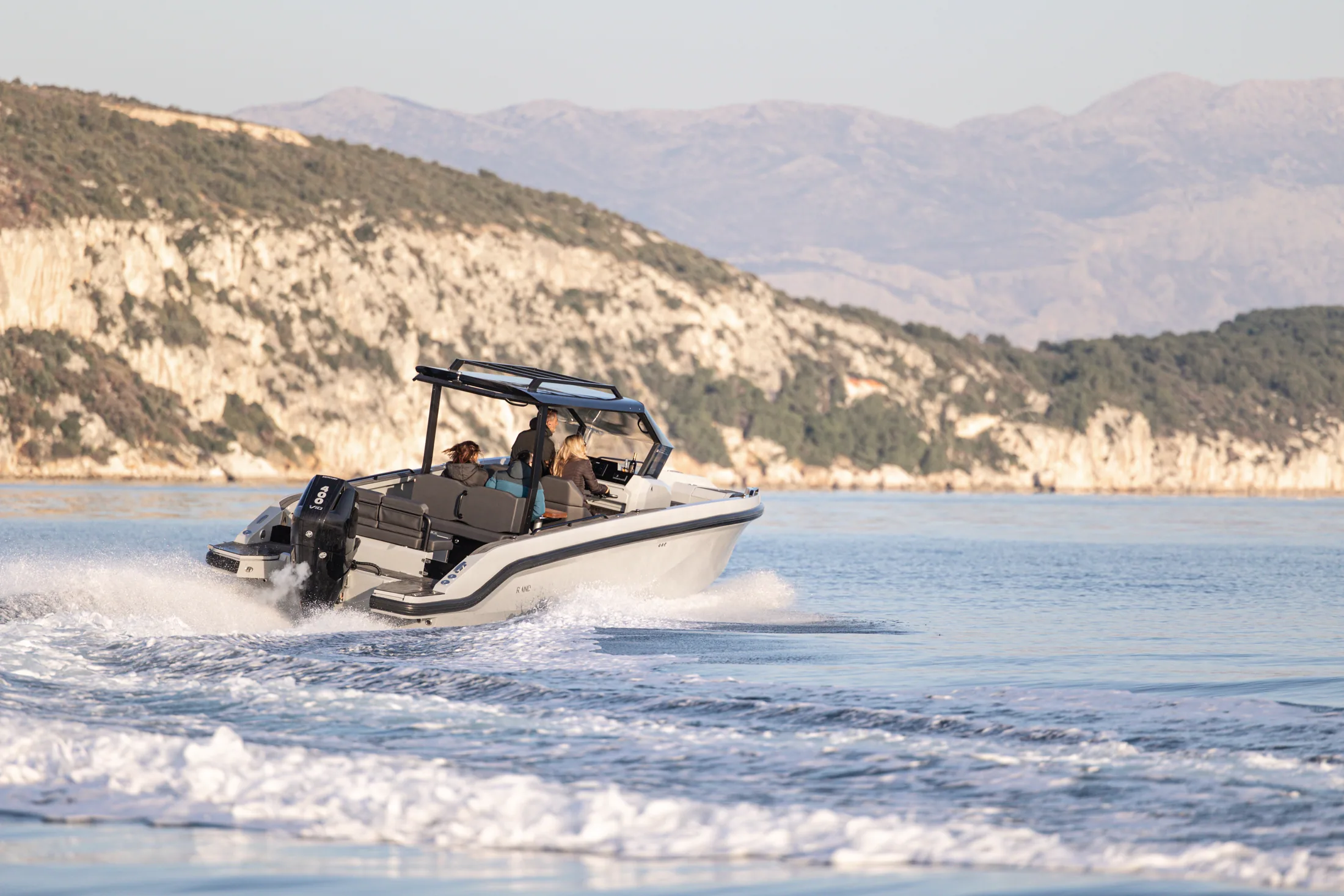 Escape 29 with inboard power below limestone cliffs