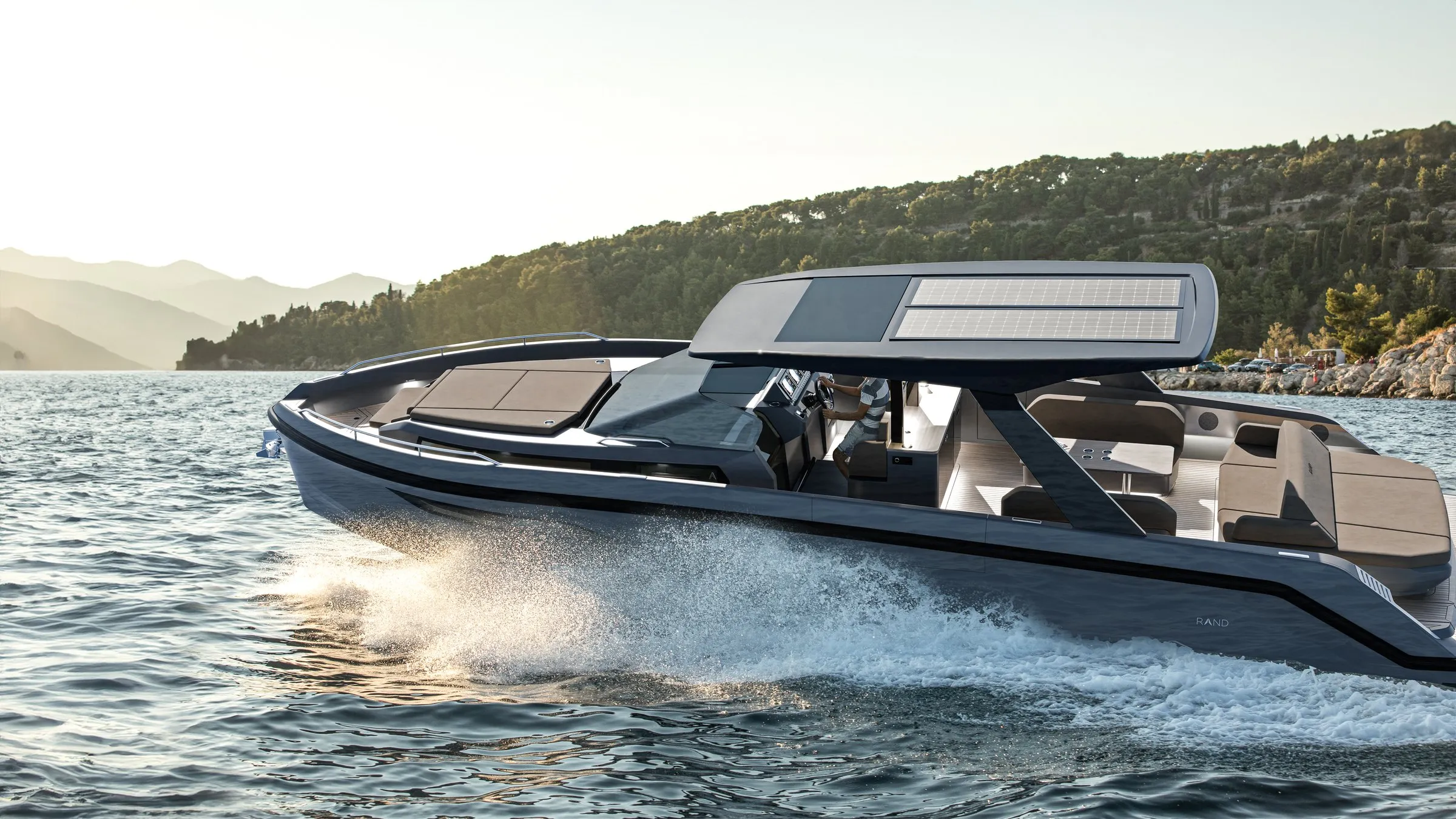 Escape 44 at speed along a wooded coast