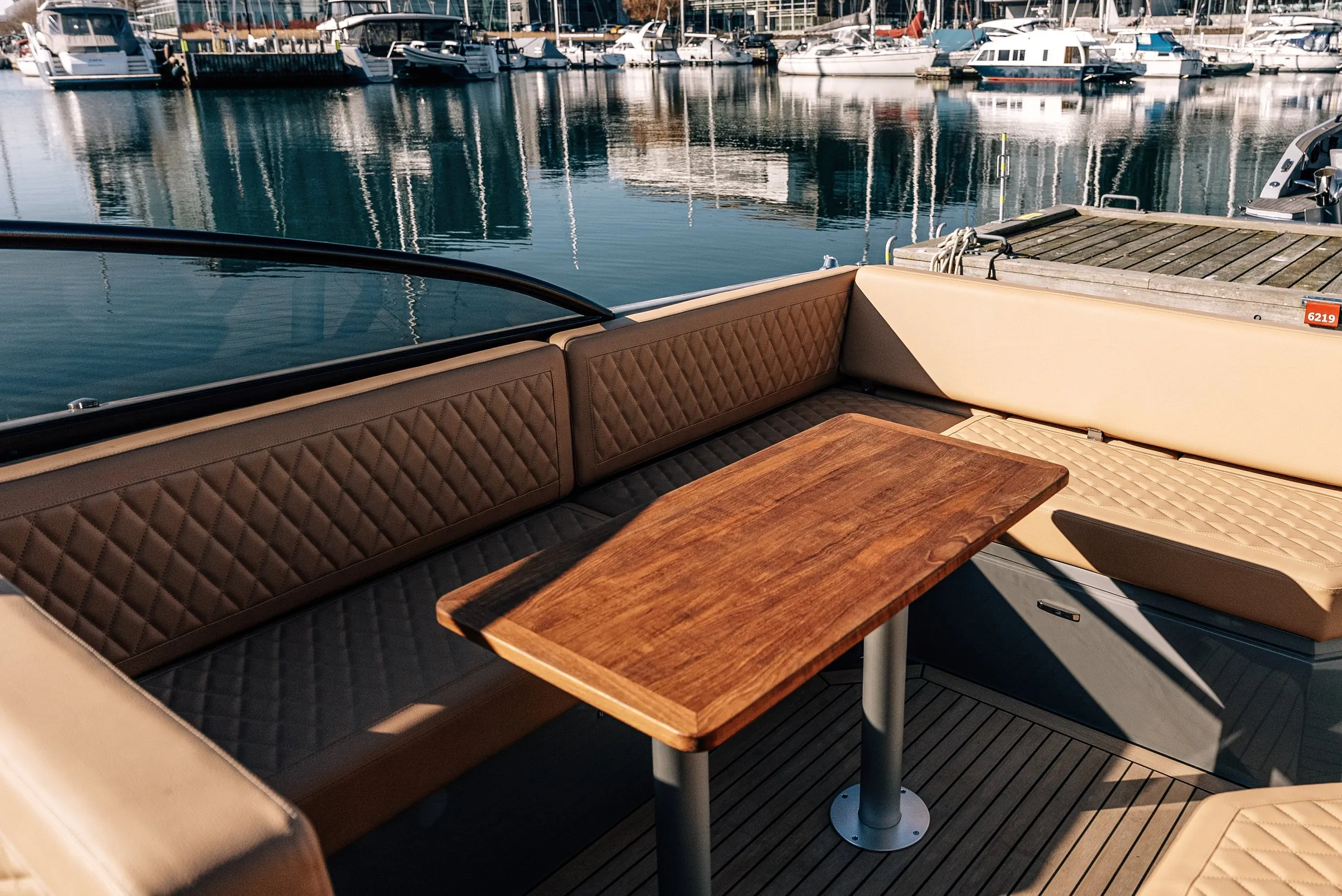 Diamond-stitched seating around the cockpit table of Supreme 27
